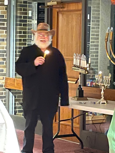 Rabbi Jacob lights the menorah